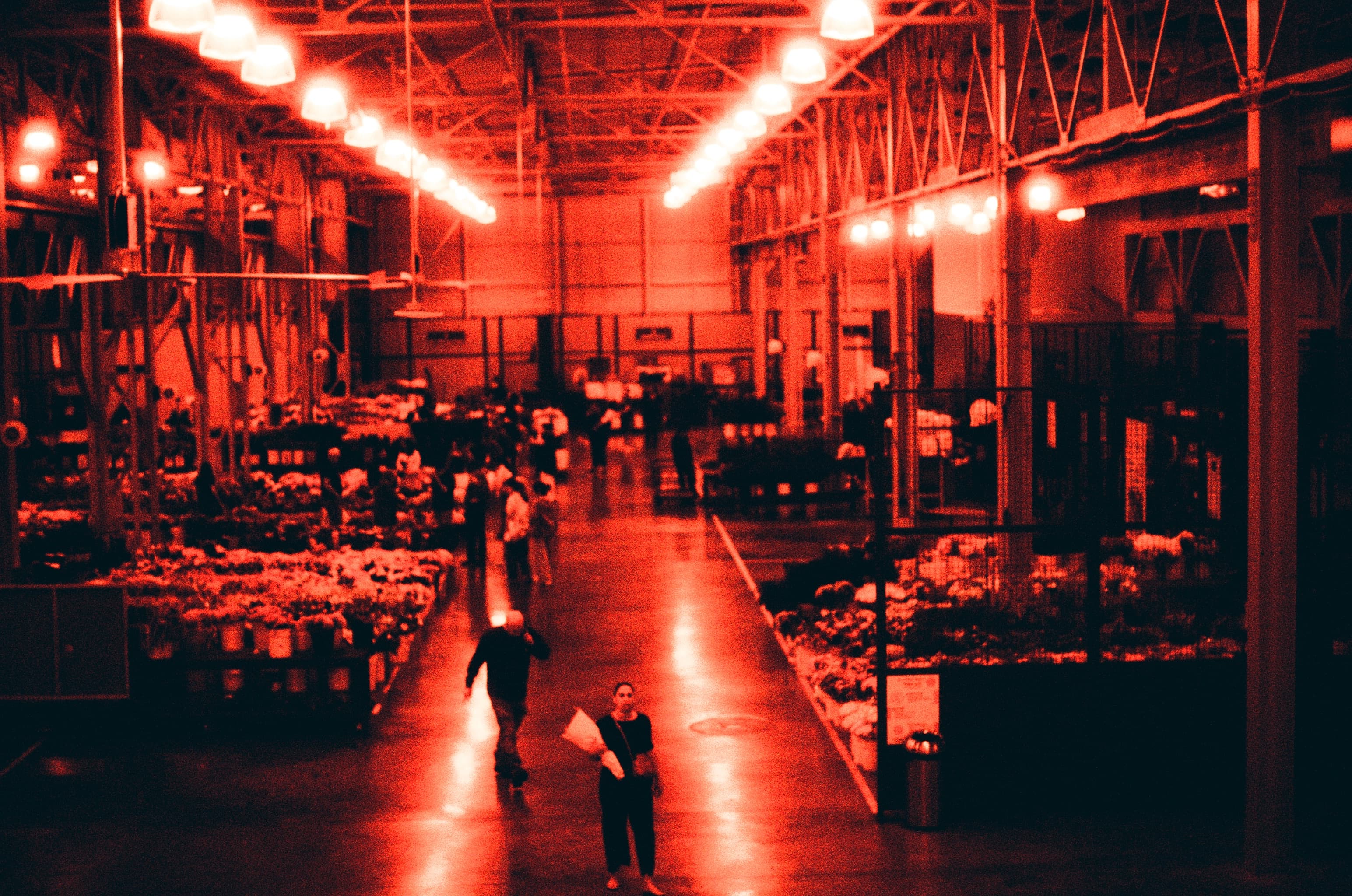 An indoor market photographed in red and black
